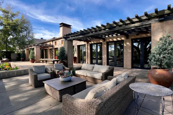 a view of a patio with couches and potted plants