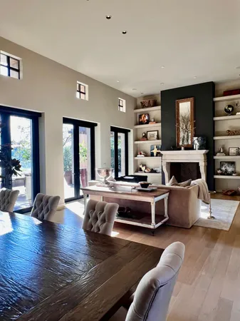 a living room with fireplace furniture and a wooden floor