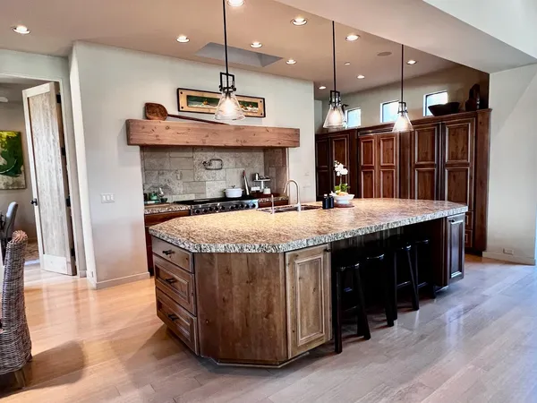 a kitchen with a refrigerator a sink and a microwave