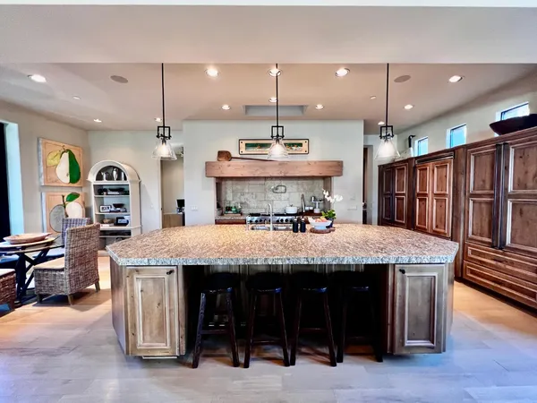 a large kitchen with a table and chairs