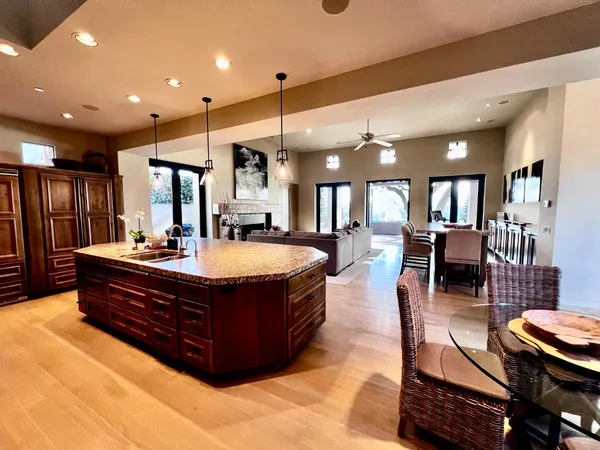a living room with furniture a table and kitchen view
