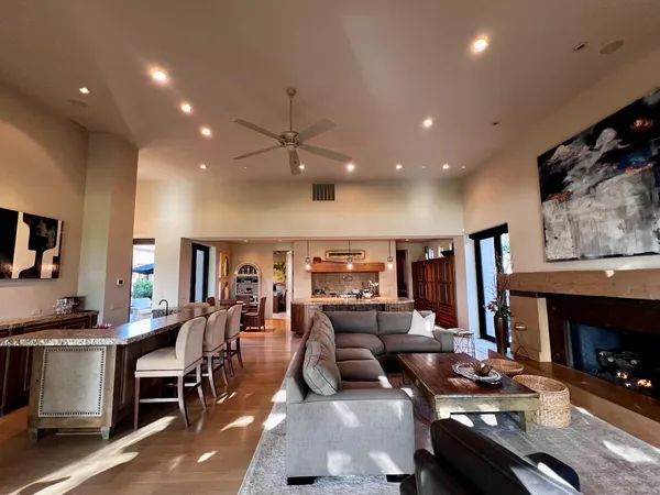 a living room with lots of furniture and kitchen view