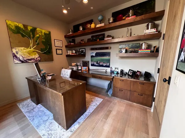 a kitchen with stainless steel appliances granite countertop a lot of cabinets