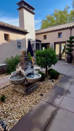 a view of a house with backyard and sitting area