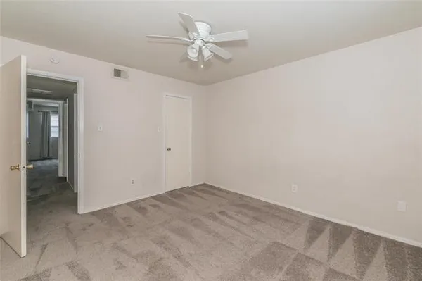 an empty room with fan and a ceiling fan
