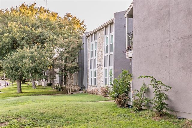 5111 Skillman Street, Unit 128 Dallas, TX 75206 - Photo 3 of 29 a view of a tall brick building next to a big yard