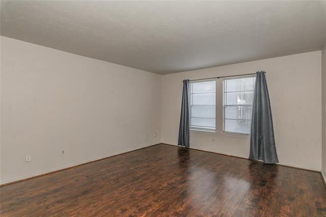 5111 Skillman Street, Unit 128 Dallas, TX 75206 - Photo 9 of 29 an empty room with wooden floor and windows