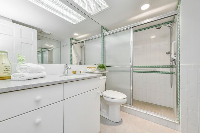 a bathroom with a sink toilet and shower