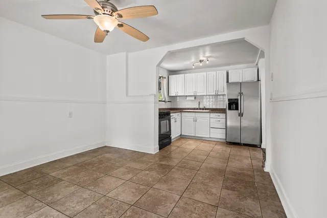 a kitchen with kitchen island a sink appliances and cabinets