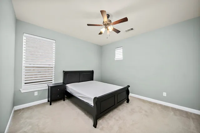 a bedroom with a bed and window