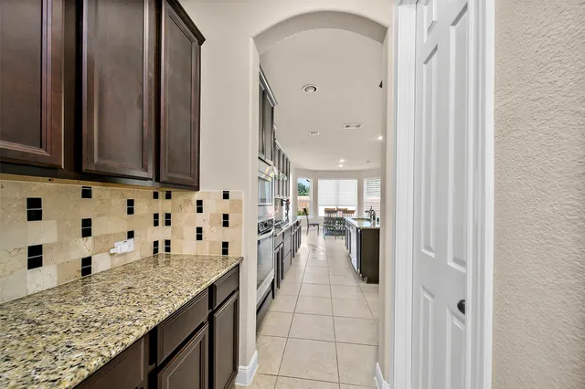 a kitchen with granite countertop a sink and cabinets
