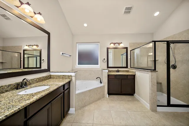 a spacious bathroom with a granite countertop sink and a mirror