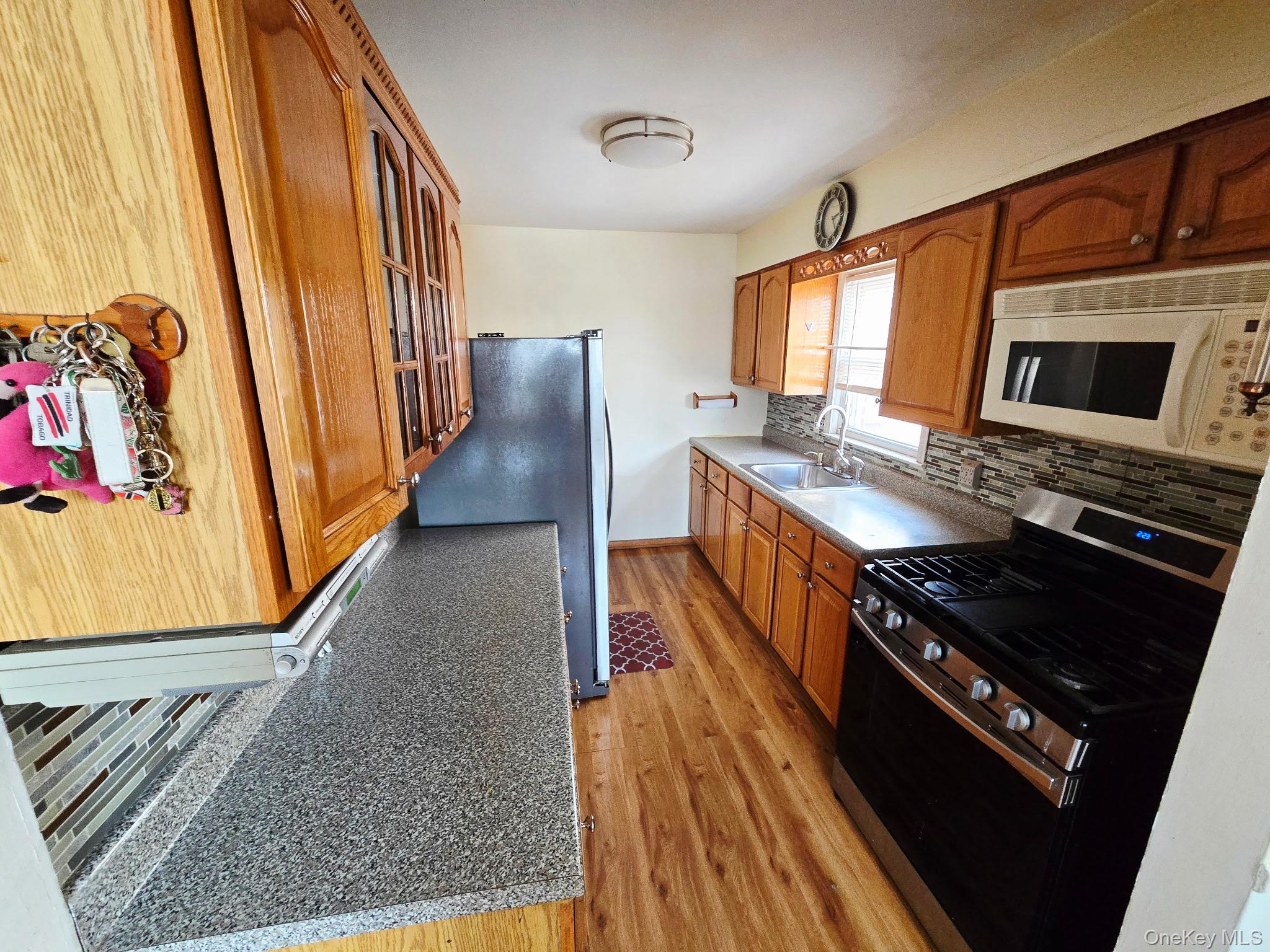 60 Liberty Boulevard Valley Stream, NY 11580 - Photo 5 of 10 a kitchen with stainless steel appliances granite countertop a stove and a sink