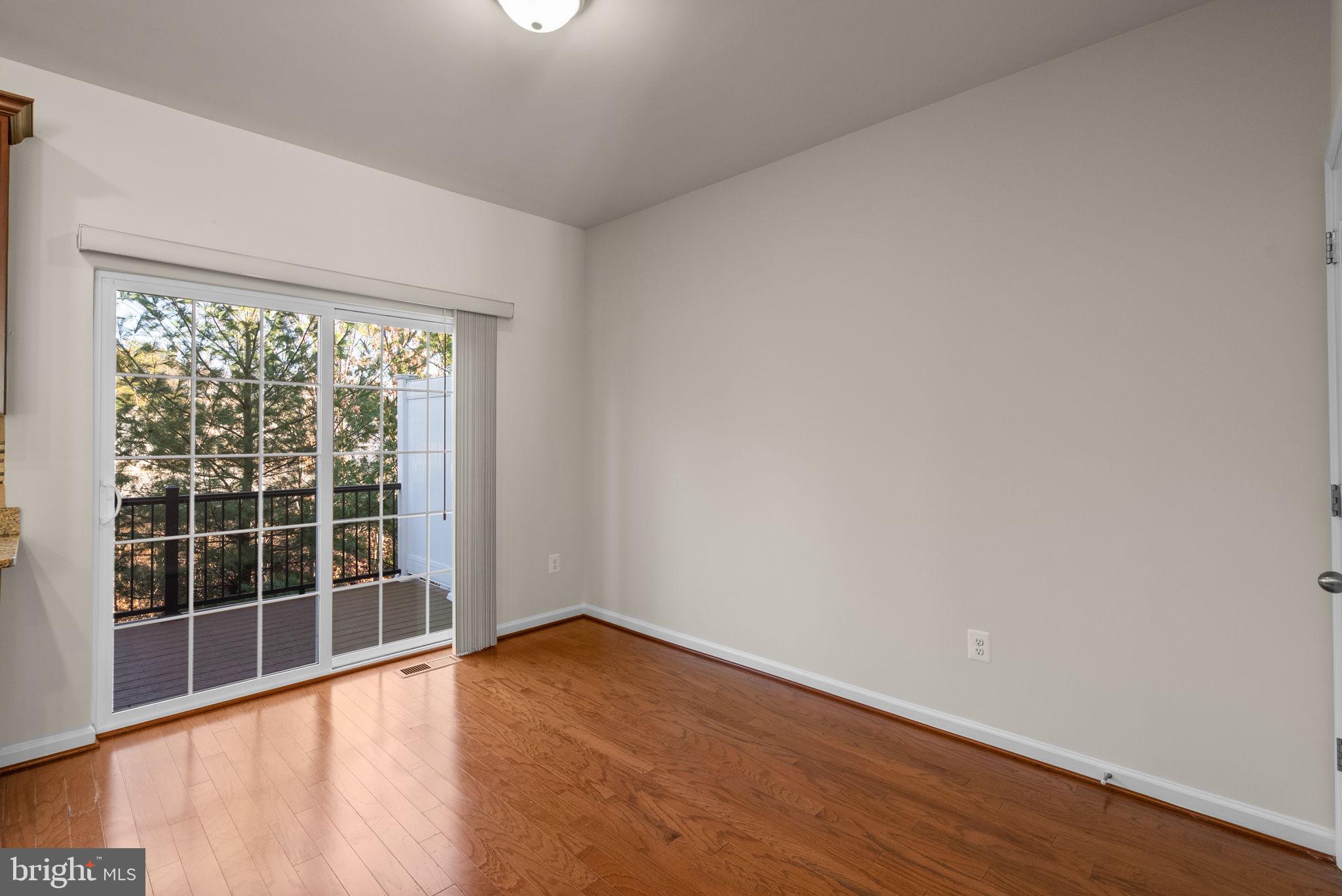 8012 Alchemy Way Elkridge, MD 21075 - Photo 11 of 46 an empty room with wooden floor and windows