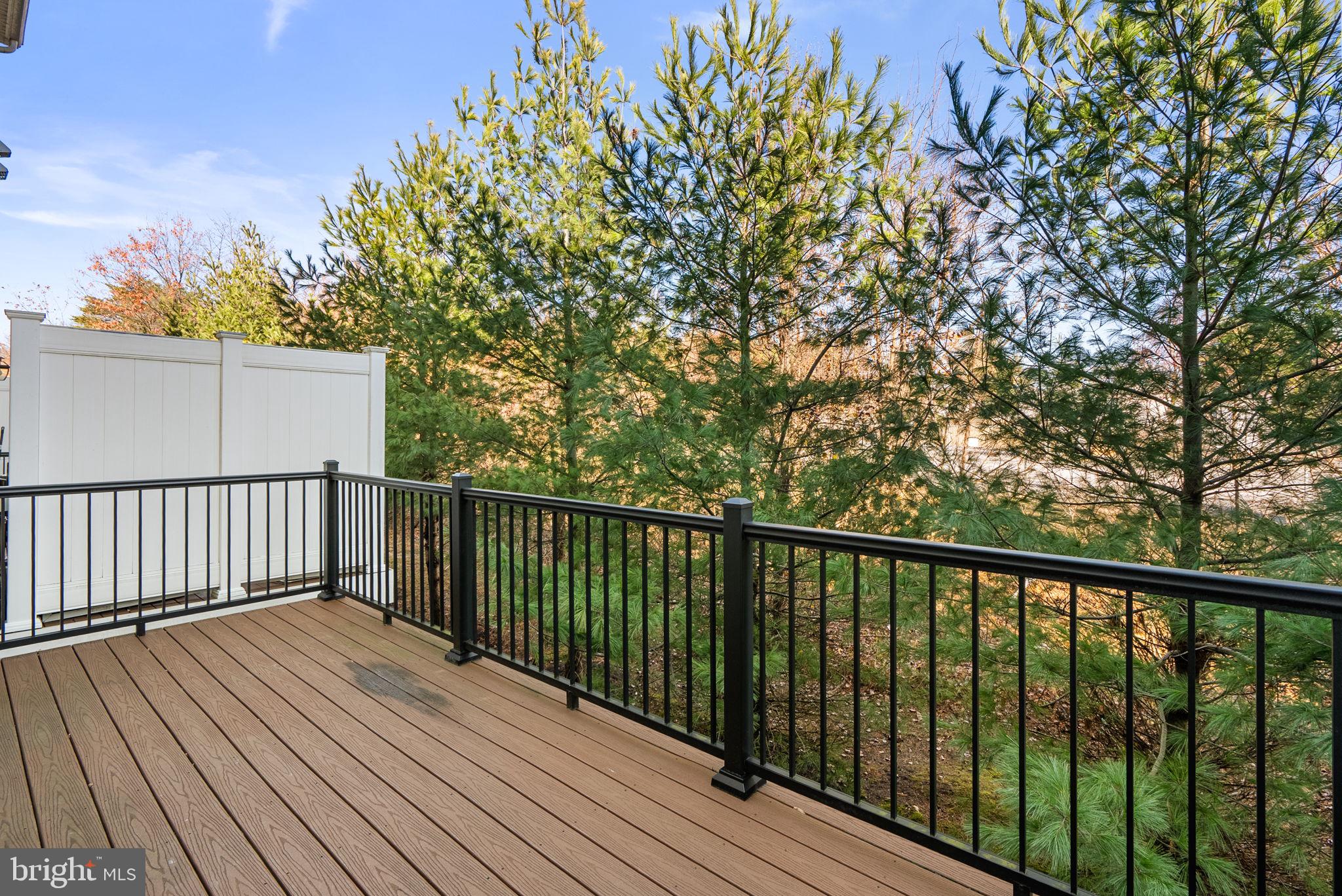8012 Alchemy Way Elkridge, MD 21075 - Photo 13 of 46 a balcony with wooden floor and fence