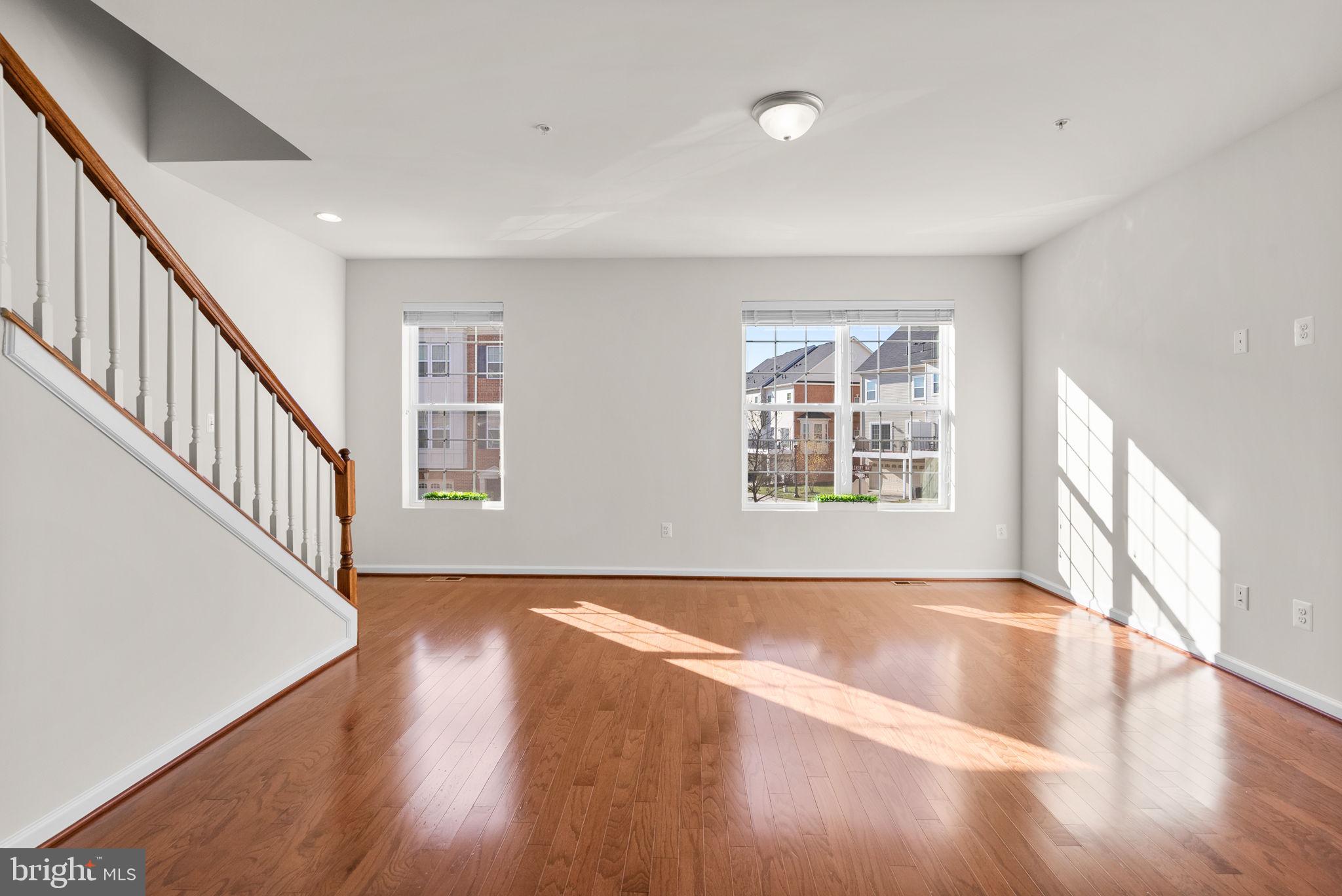 8012 Alchemy Way Elkridge, MD 21075 - Photo 15 of 46 a view of an empty room with wooden floor and a window