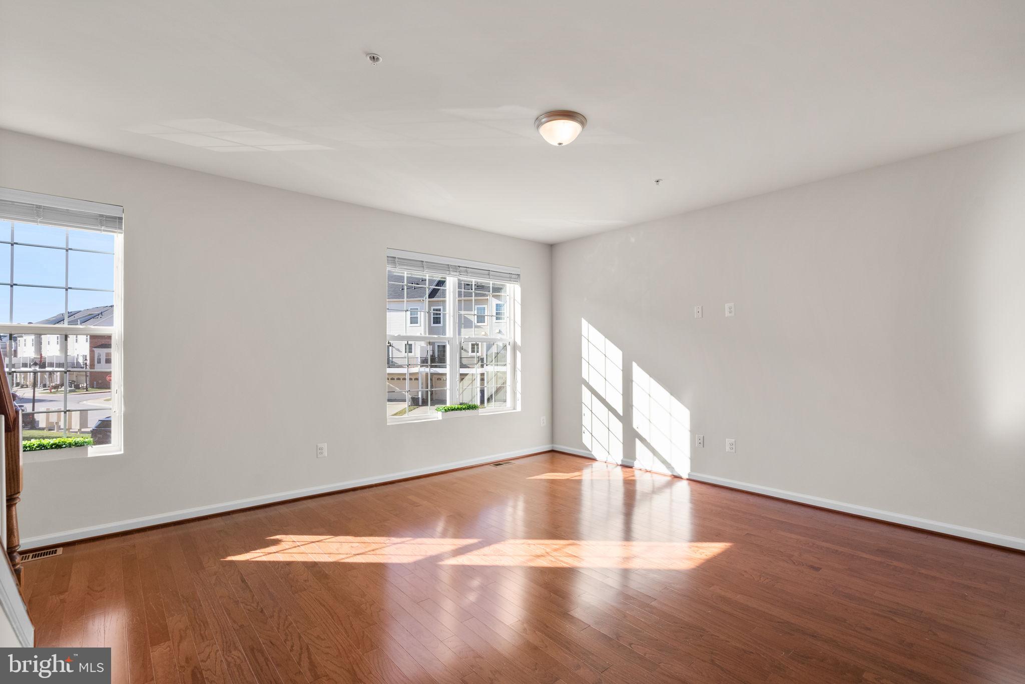 8012 Alchemy Way Elkridge, MD 21075 - Photo 16 of 46 a view of an empty room with wooden floor and a window