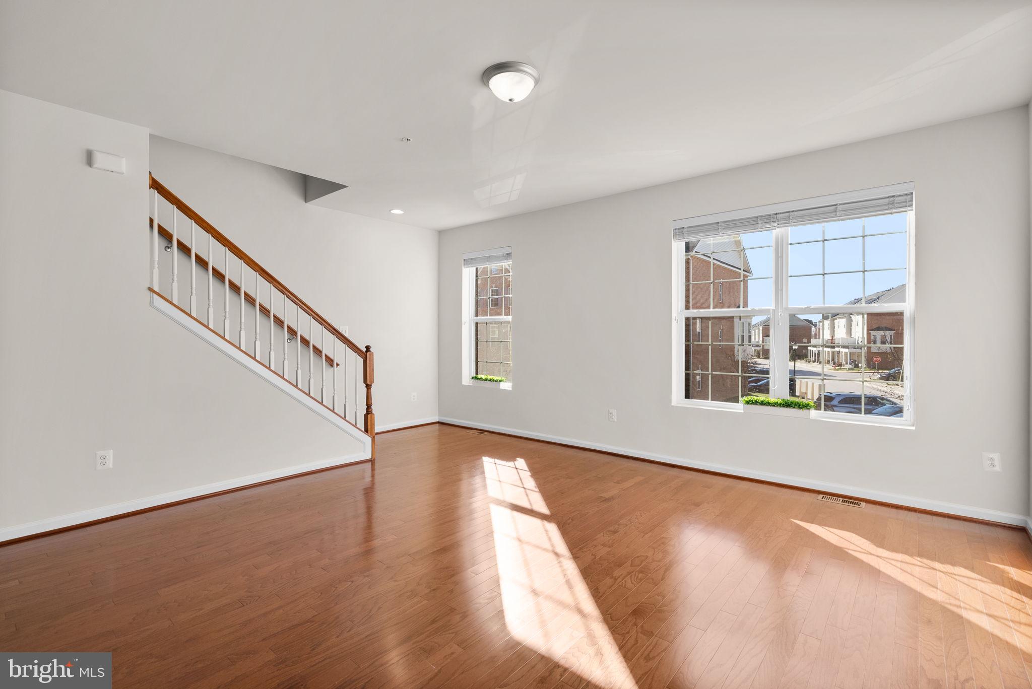 8012 Alchemy Way Elkridge, MD 21075 - Photo 17 of 46 a view of an empty room with wooden floor and a window