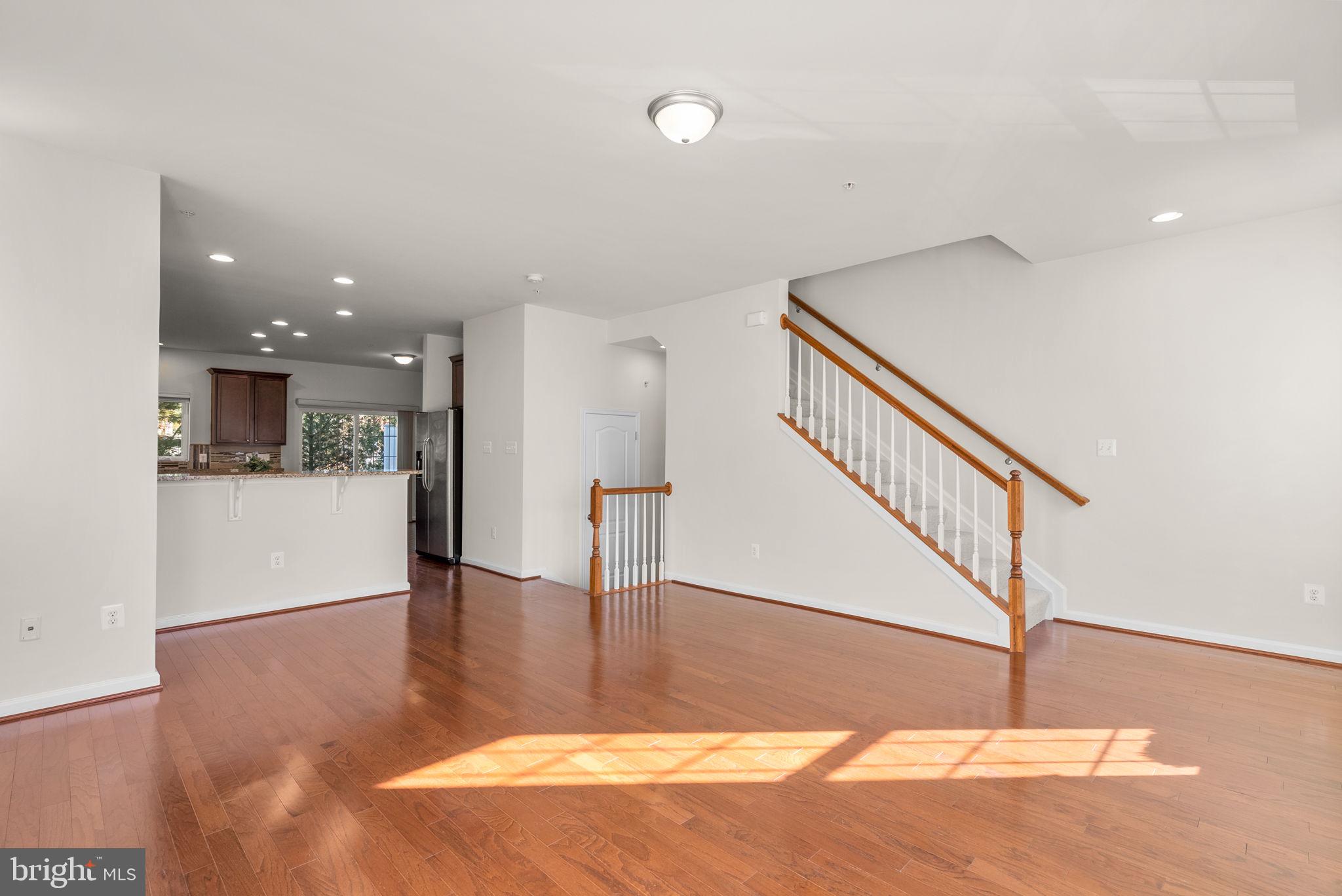 8012 Alchemy Way Elkridge, MD 21075 - Photo 18 of 46 a view of a hallway with wooden floor and staircase