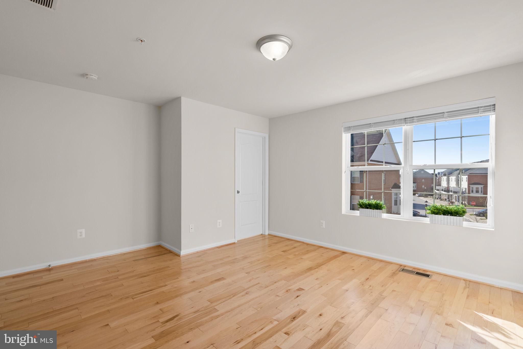 8012 Alchemy Way Elkridge, MD 21075 - Photo 23 of 46 a view of empty room with wooden floor and fan