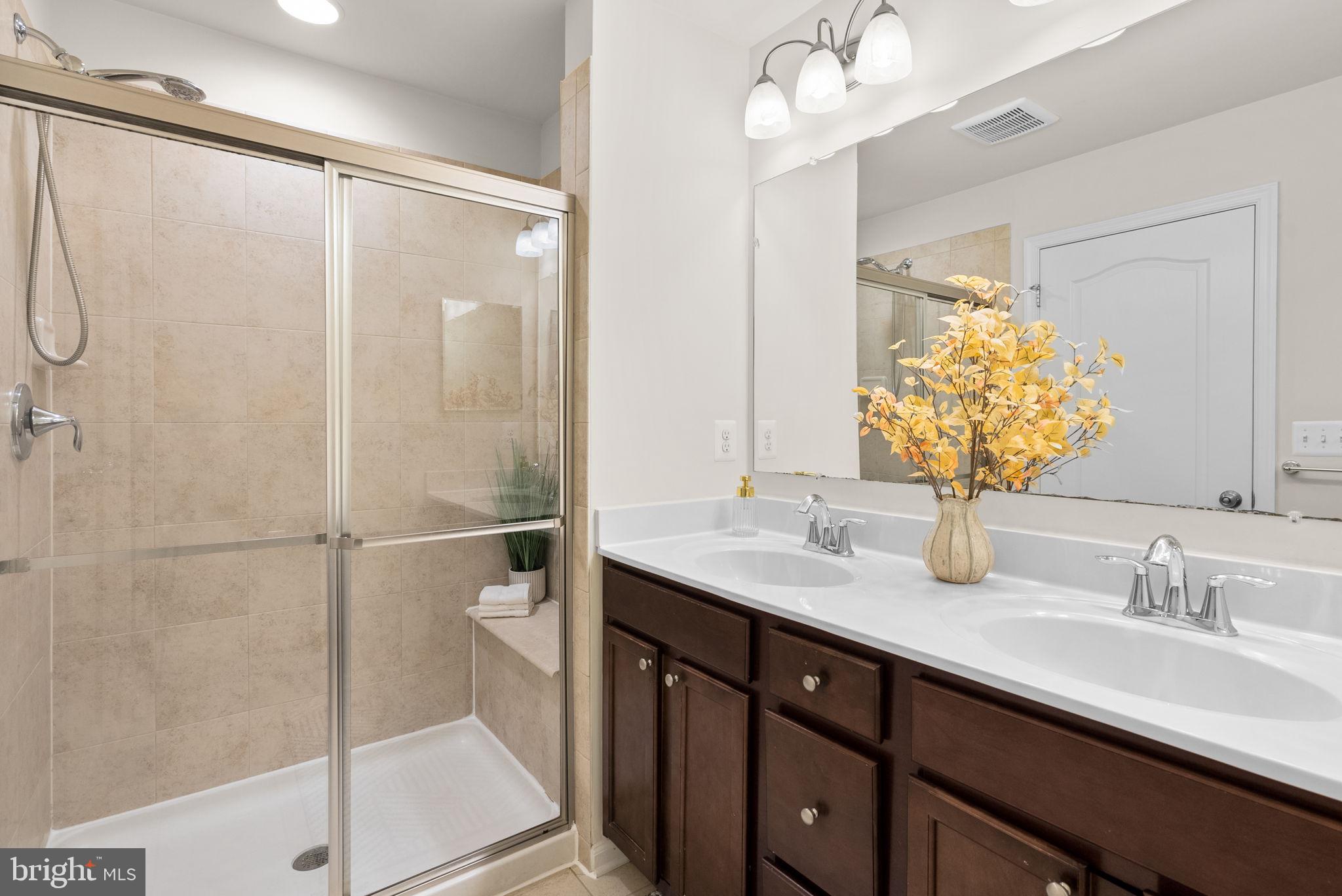 8012 Alchemy Way Elkridge, MD 21075 - Photo 24 of 46 a bathroom with a double vanity sink mirror and toilet