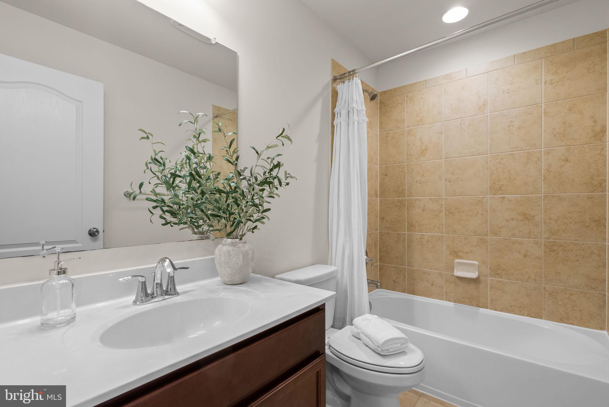 8012 Alchemy Way Elkridge, MD 21075 - Photo 30 of 46 a bathroom with a sink a toilet a tub and shower