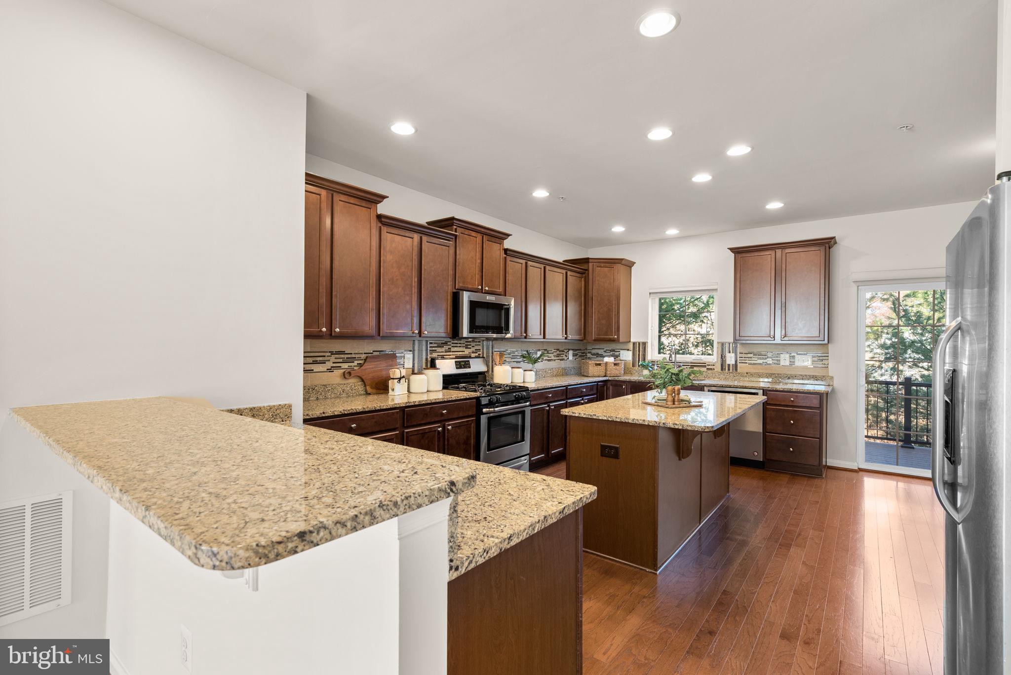 8012 Alchemy Way Elkridge, MD 21075 - Photo 4 of 46 a kitchen with a center island appliances and cabinets
