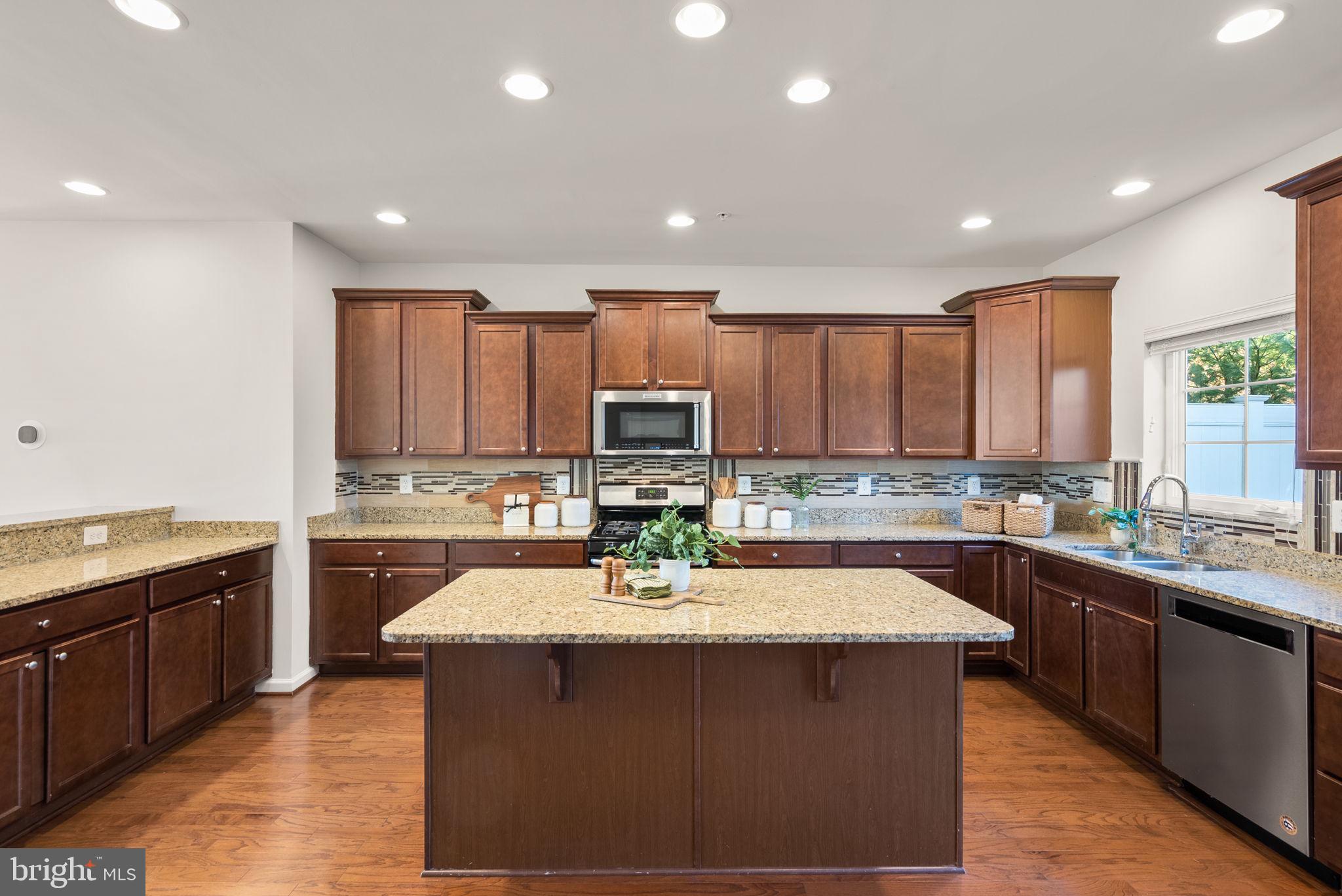 8012 Alchemy Way Elkridge, MD 21075 - Photo 5 of 46 a kitchen with a sink stove cabinets and window