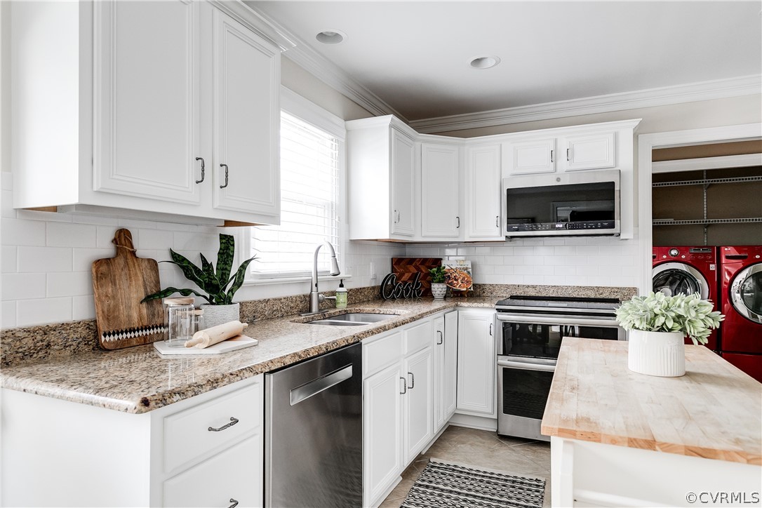 3300 East Weyburn Road Richmond, VA 23235 - Photo 21 of 46 a kitchen with stainless steel appliances granite countertop a sink a stove top oven a counter space and cabinets