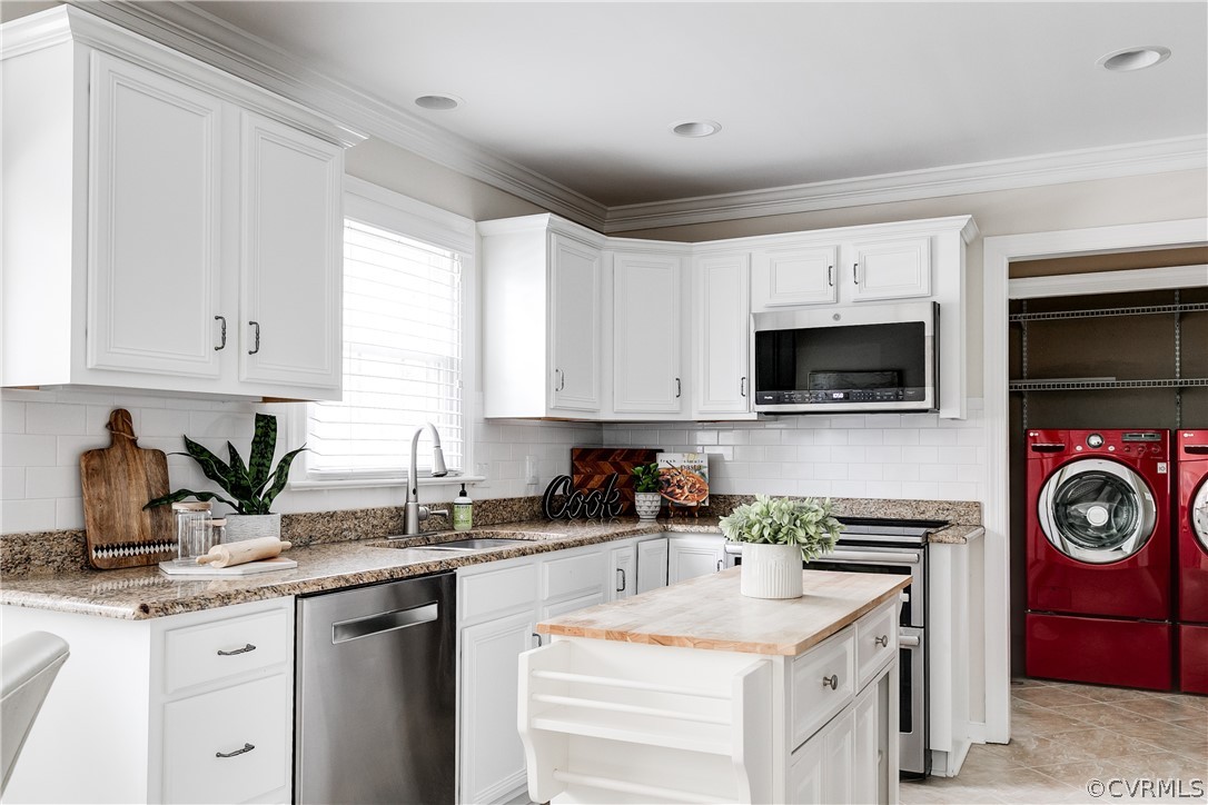 3300 East Weyburn Road Richmond, VA 23235 - Photo 25 of 46 a kitchen with stainless steel appliances granite countertop a sink a stove a microwave and wooden cabinets