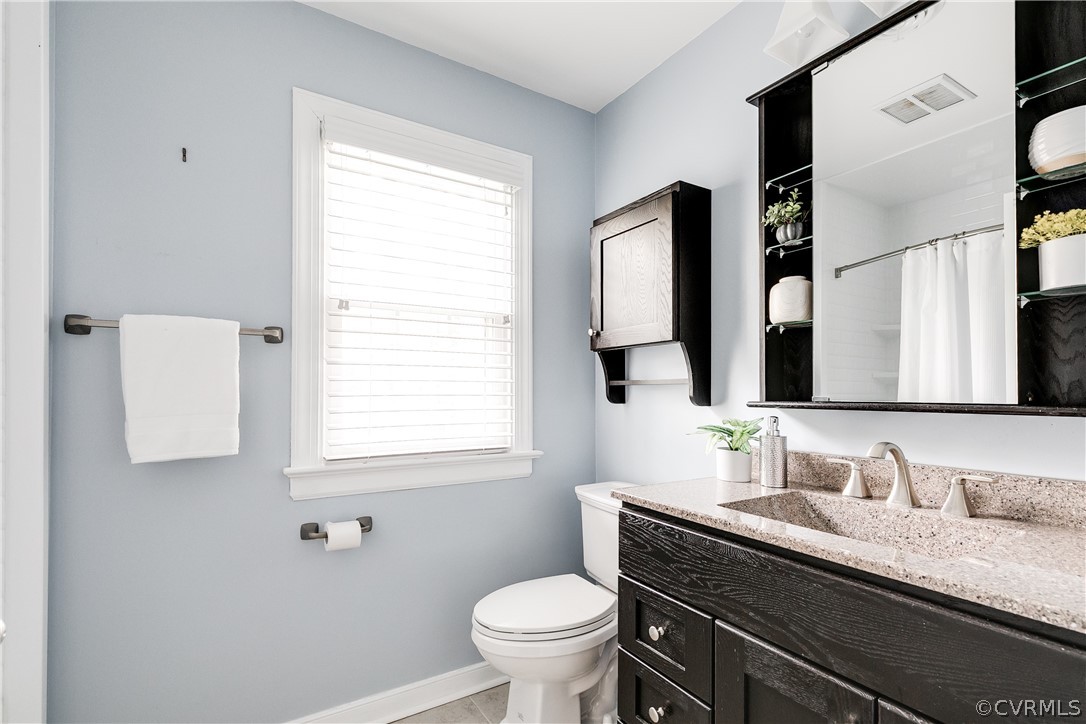 3300 East Weyburn Road Richmond, VA 23235 - Photo 38 of 46 a bathroom with a granite countertop toilet sink and a mirror