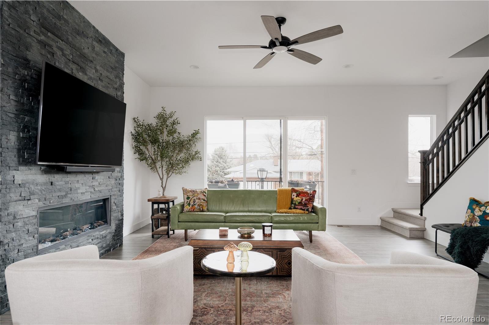 11890 West 52nd Avenue Wheat Ridge, CO 80033 - Photo 1 of 44 a living room with furniture fireplace and a flat screen tv