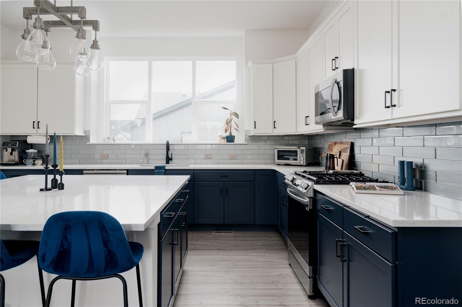 11890 West 52nd Avenue Wheat Ridge, CO 80033 - Photo 14 of 44 a kitchen with stainless steel appliances granite countertop a sink stove and refrigerator