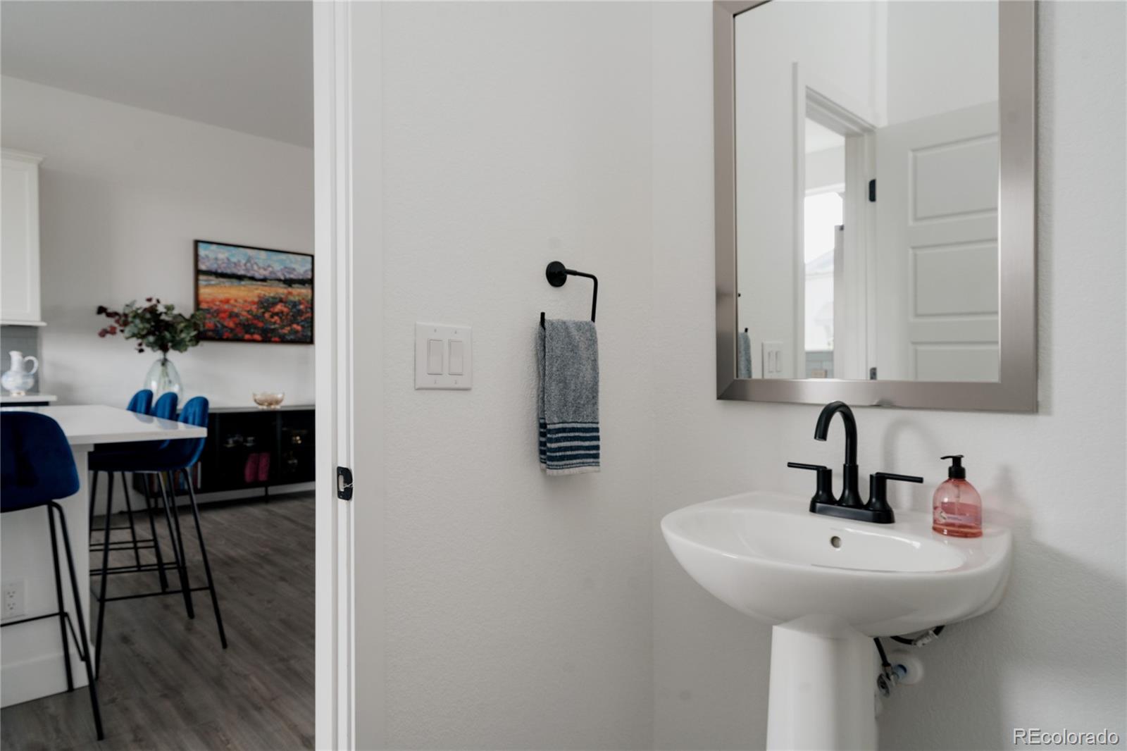11890 West 52nd Avenue Wheat Ridge, CO 80033 - Photo 18 of 44 a bathroom with a sink and a mirror