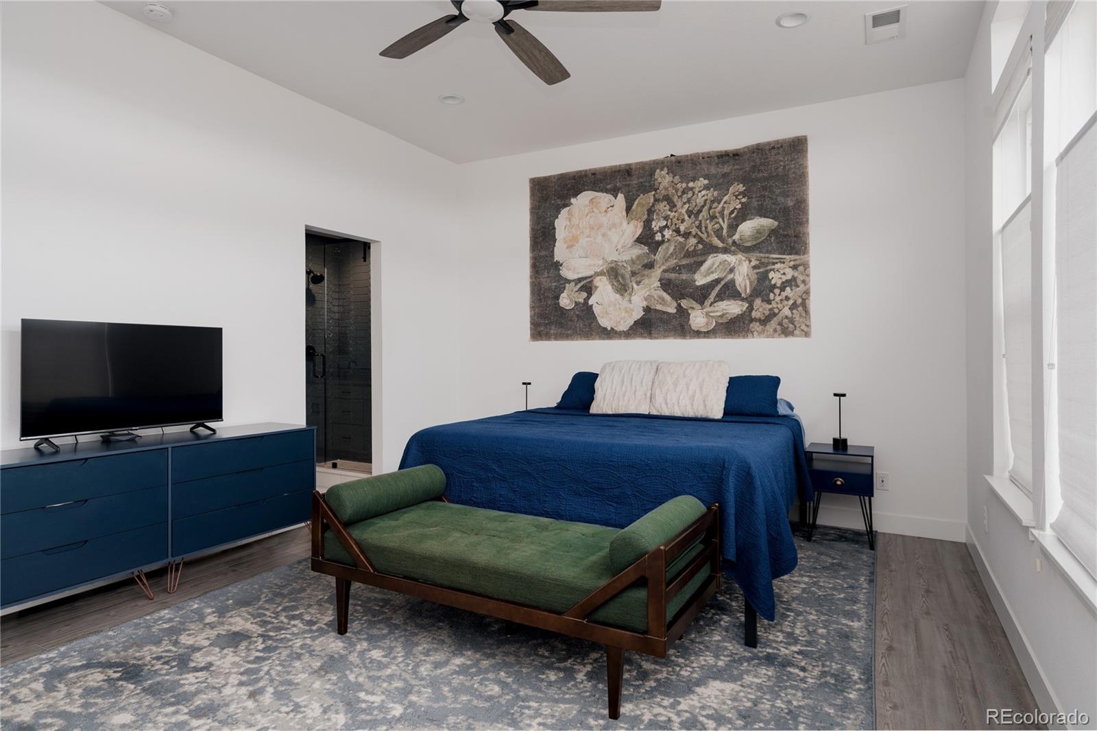 11890 West 52nd Avenue Wheat Ridge, CO 80033 - Photo 23 of 44 a bedroom with furniture and a flat screen tv