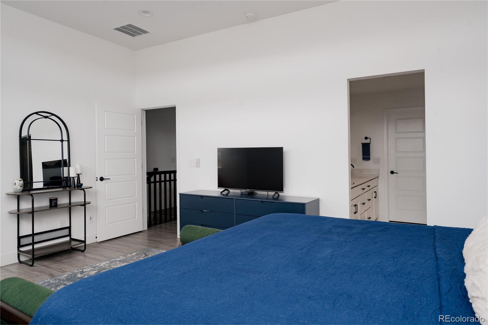 11890 West 52nd Avenue Wheat Ridge, CO 80033 - Photo 25 of 44 a bedroom with a bed and a flat screen tv