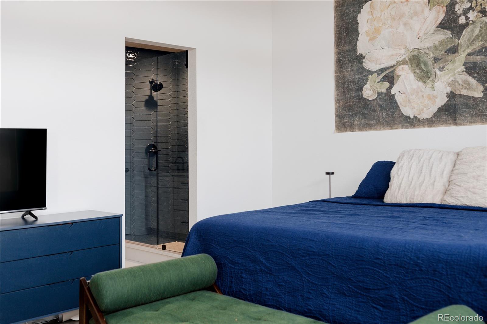 11890 West 52nd Avenue Wheat Ridge, CO 80033 - Photo 29 of 44 a bedroom with a bed and a television