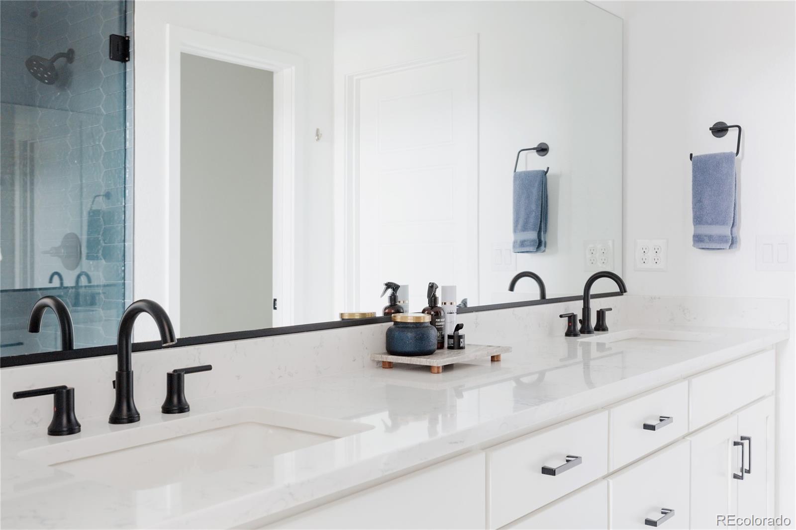 11890 West 52nd Avenue Wheat Ridge, CO 80033 - Photo 31 of 44 a bathroom with a sink and a mirror