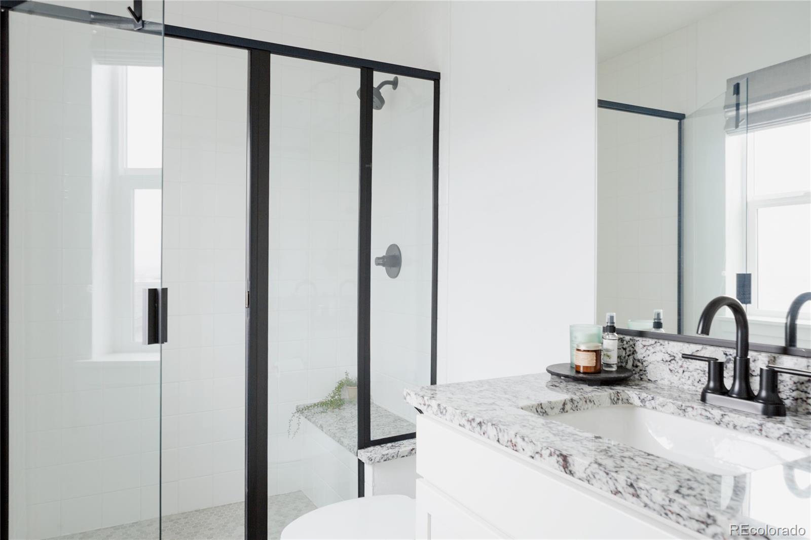 11890 West 52nd Avenue Wheat Ridge, CO 80033 - Photo 37 of 44 a bathroom with a granite countertop sink and a mirror