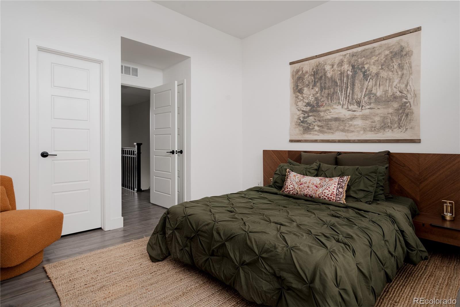 11890 West 52nd Avenue Wheat Ridge, CO 80033 - Photo 38 of 44 a bedroom with a bed and a painting on the wall