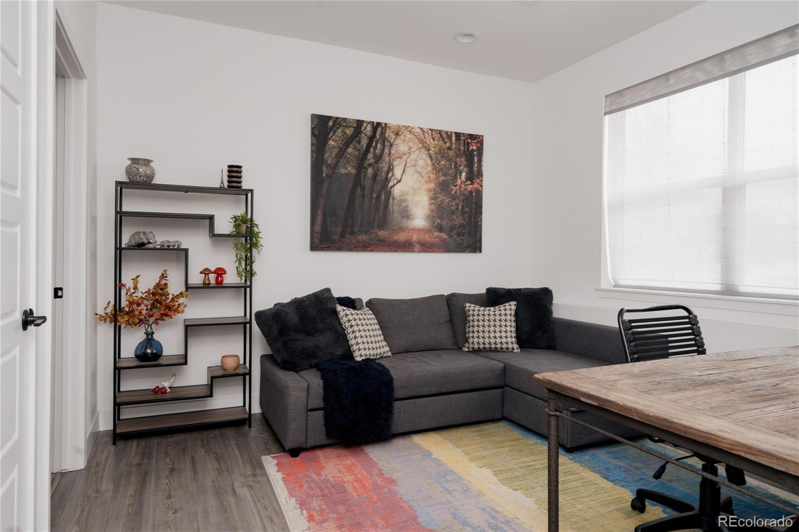 11890 West 52nd Avenue Wheat Ridge, CO 80033 - Photo 40 of 44 a living room with furniture and a wooden floor