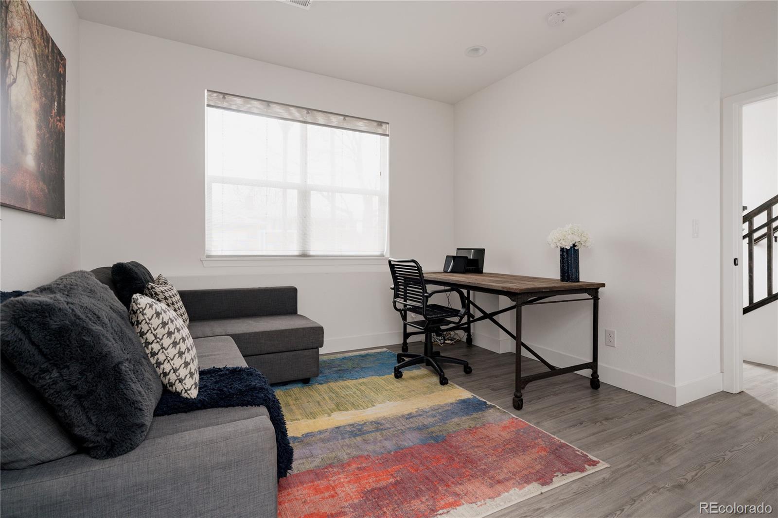 11890 West 52nd Avenue Wheat Ridge, CO 80033 - Photo 41 of 44 a living room with furniture and a window