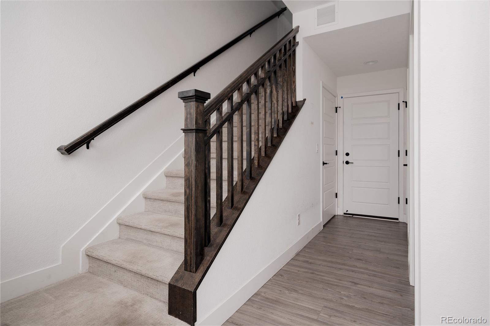 11890 West 52nd Avenue Wheat Ridge, CO 80033 - Photo 5 of 44 a view of staircase with wooden floor and white walls