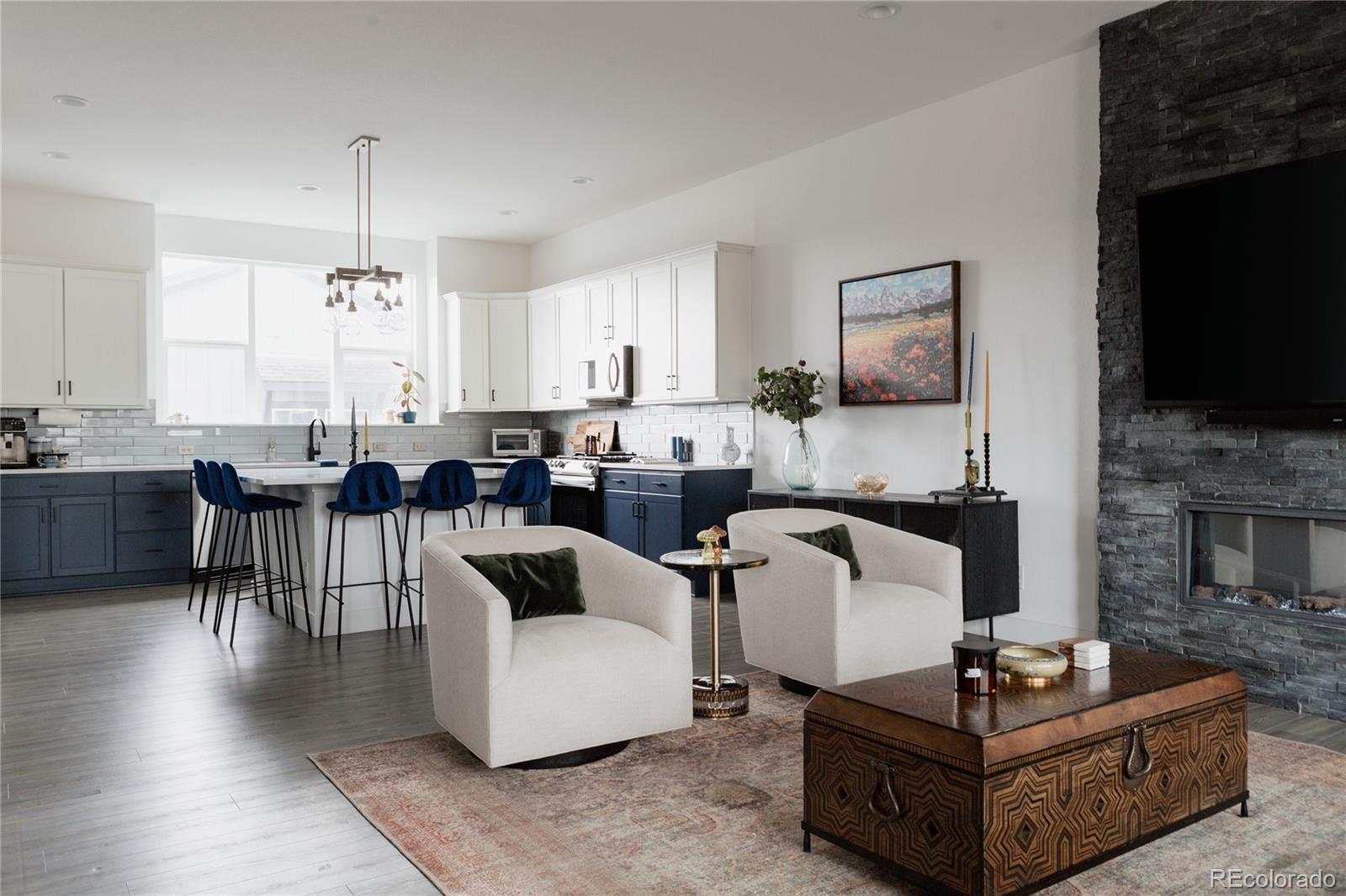 11890 West 52nd Avenue Wheat Ridge, CO 80033 - Photo 6 of 44 a living room with furniture a dining table and a fireplace