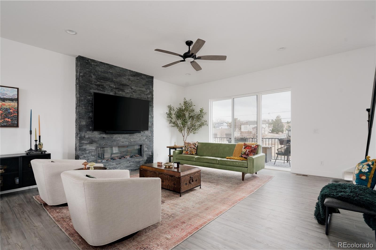 11890 West 52nd Avenue Wheat Ridge, CO 80033 - Photo 7 of 44 a living room with furniture and a flat screen tv