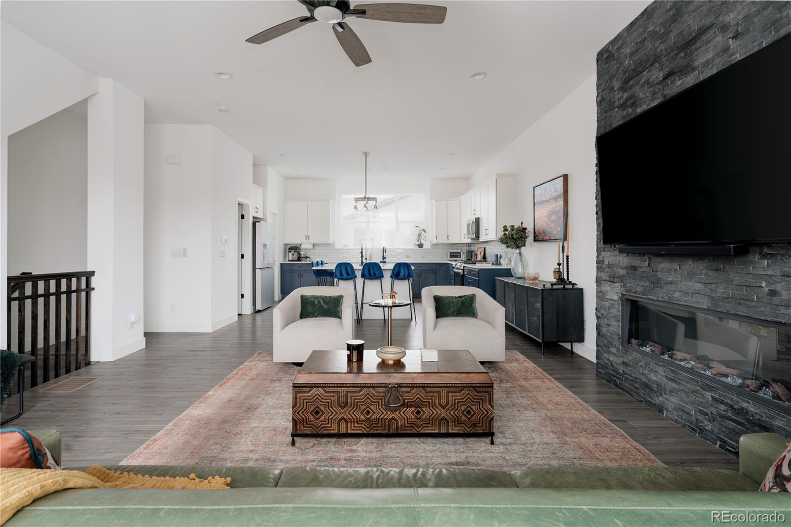 11890 West 52nd Avenue Wheat Ridge, CO 80033 - Photo 10 of 44 a living room with fireplace furniture and a flat screen tv