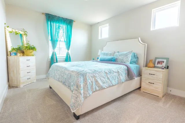 a bedroom with a bed and a dresser