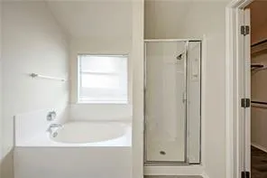 a bathroom with a bathtub and a shower