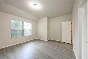 1962 Rachel Lane Round Rock, TX 78664 - Photo 16 of 22 an empty room with wooden floor and windows