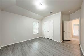 1962 Rachel Lane Round Rock, TX 78664 - Photo 17 of 22 an empty room with wooden floor and windows